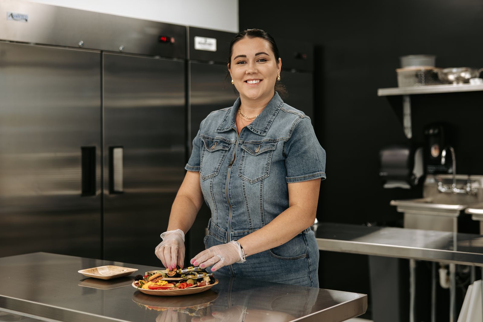 Modern Meze's founder arranging a meze board in the kitchen